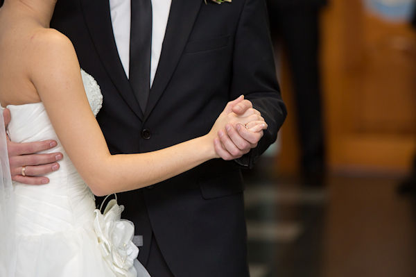 the groom holds the bride by a hand at a wedding